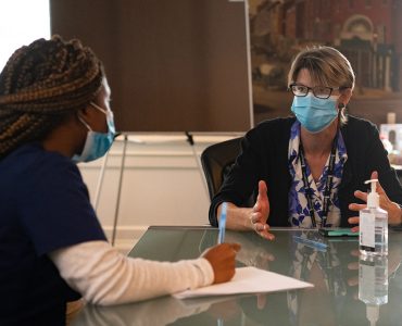 School of Nursing alumnus Rashida Charles (left) and School of Nursing assistant professor and researcher Marik Moen work at the Lord Baltimore Triage, Respite, and Isolation (TRI) Center, which treats people infected with COVID-19 who have no safe place to isolate.
