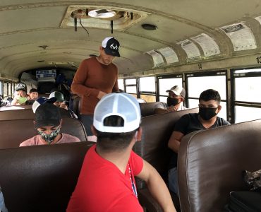 Migrant/seasonal workers from Florida ride a bus to Westover migrant labor camp on the Eastern Shore. The workers typically work 11- to 12-hour shifts there. Photo courtesy of Devon Payne-Sturges