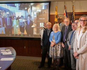 Leaders from the University of Maryland, Baltimore, and virtually, the University of Costa Rica, celebrate the signing of a memorandum of understanding between the two institutions, paving the way to collaborative opportunities exploring aging research.