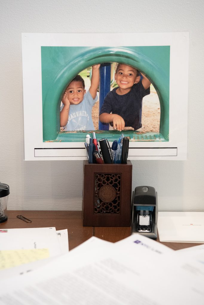 A photo from 15 years ago of Dean Hutchins’ two sons is on a corkboard behind her desk.  “It reminds me of how much they have grown and how privileged I am to be their mom!” she said. “They are the most remarkable human beings. They regularly amaze me with their resilience, kindness, and humanity.” Photo by Matthew D’Agostino