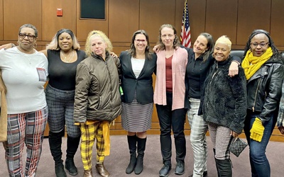 Leigh Goodmark (center), the Clinical Law Program’s co-director, poses with clients in the Maryland Carey Law Moot Courtroom. The law school celebrated the program’s anniversary with the investiture of Goodmark as the Marjorie Cook Professor of Law.
