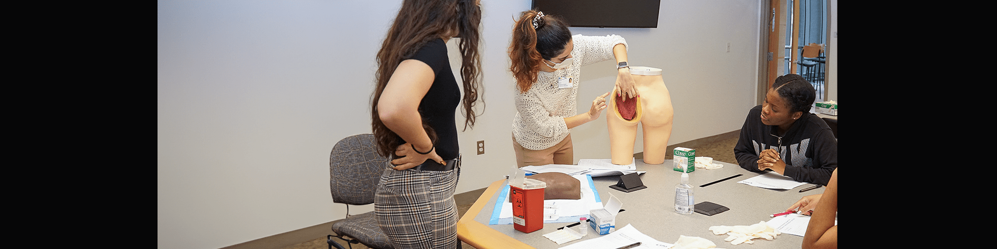 Student pharmacists receive instruction on how to administer long-acting injectables.