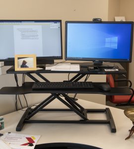 A desk with a computer on it