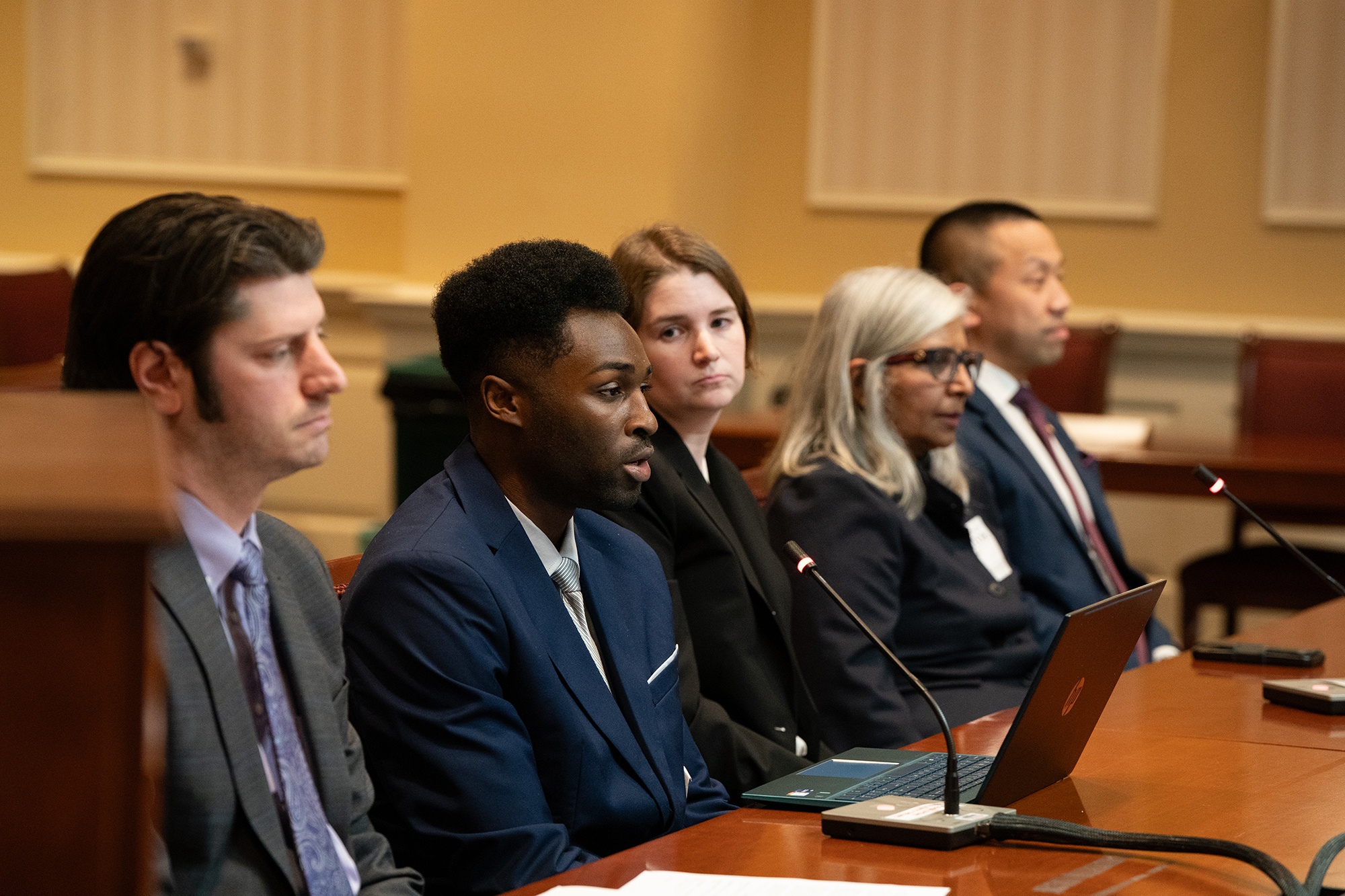 Davon Nixon (second from left), speaking at a hearing.