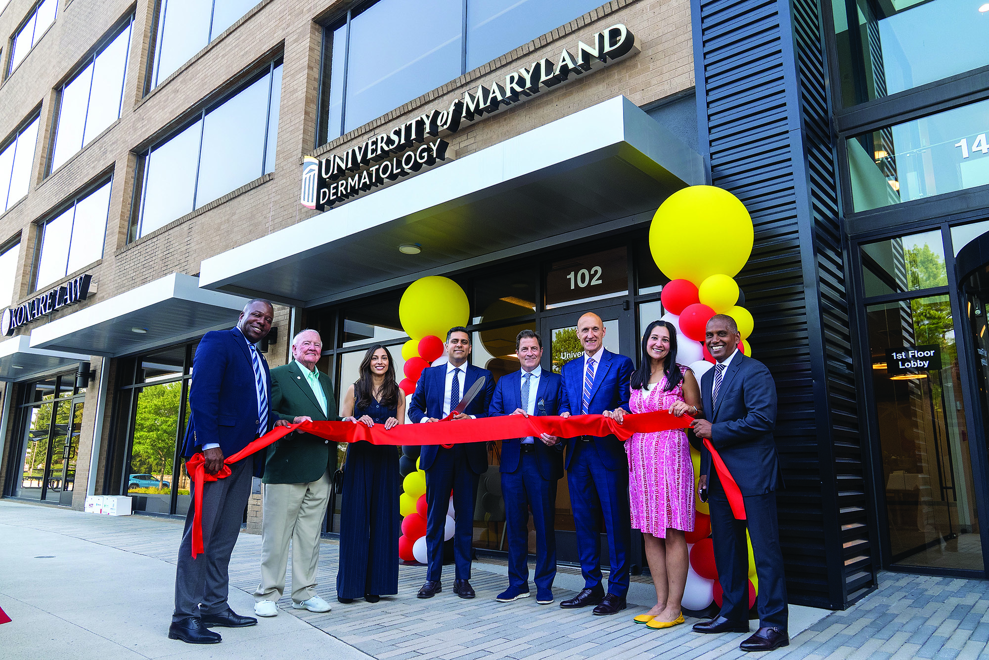 Shawn Kwatra, MD, (holding scissors) at the opening of the Maryland Itch Center and a center for precision dermatology.