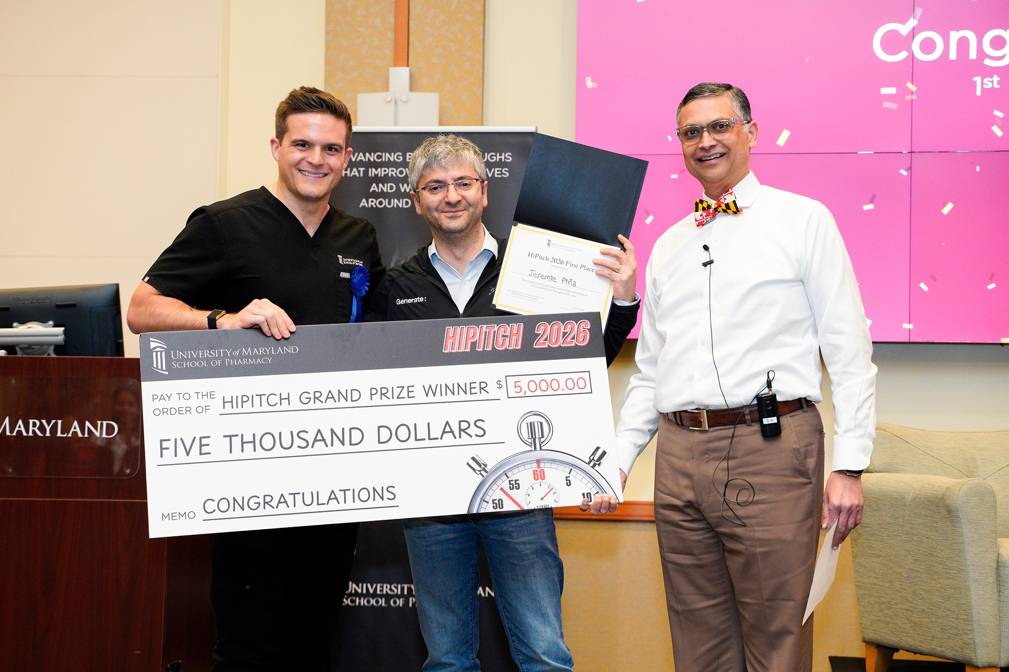 Gevorg Grigoryan, PhD (center), co-founder of Generate Biomedicines, who was the HiPitch speaker, and School of Pharmacy Felix Gyi Endowed Memorial Professor in Pharmapreneurship Joga Gobburu, PhD (right), present Jeremie Oliver Piña (left) with the HiPitch grand prize check.