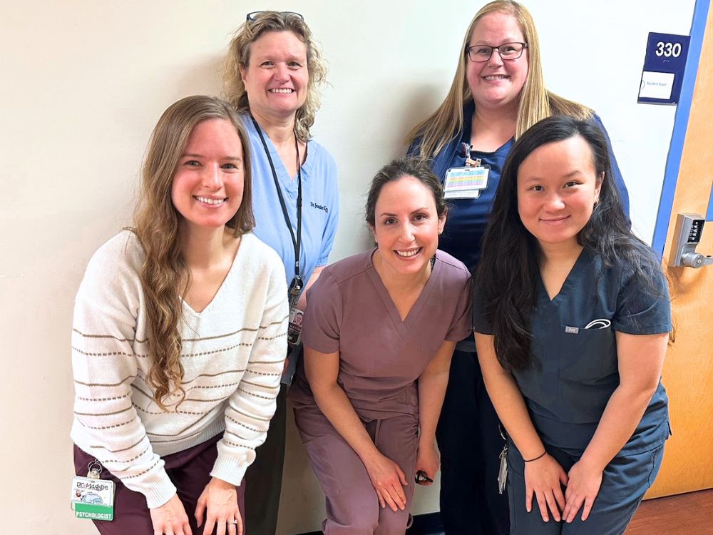 Erica Caffrey, DDS (center), and pediatric resident Gabrielle Le, DDS (front right), with the interdisciplinary team at Kennedy Krieger.
